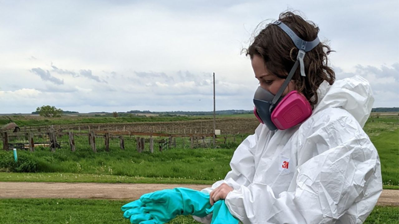 A woman wears proper PPE equipment fo use in ag health and safety