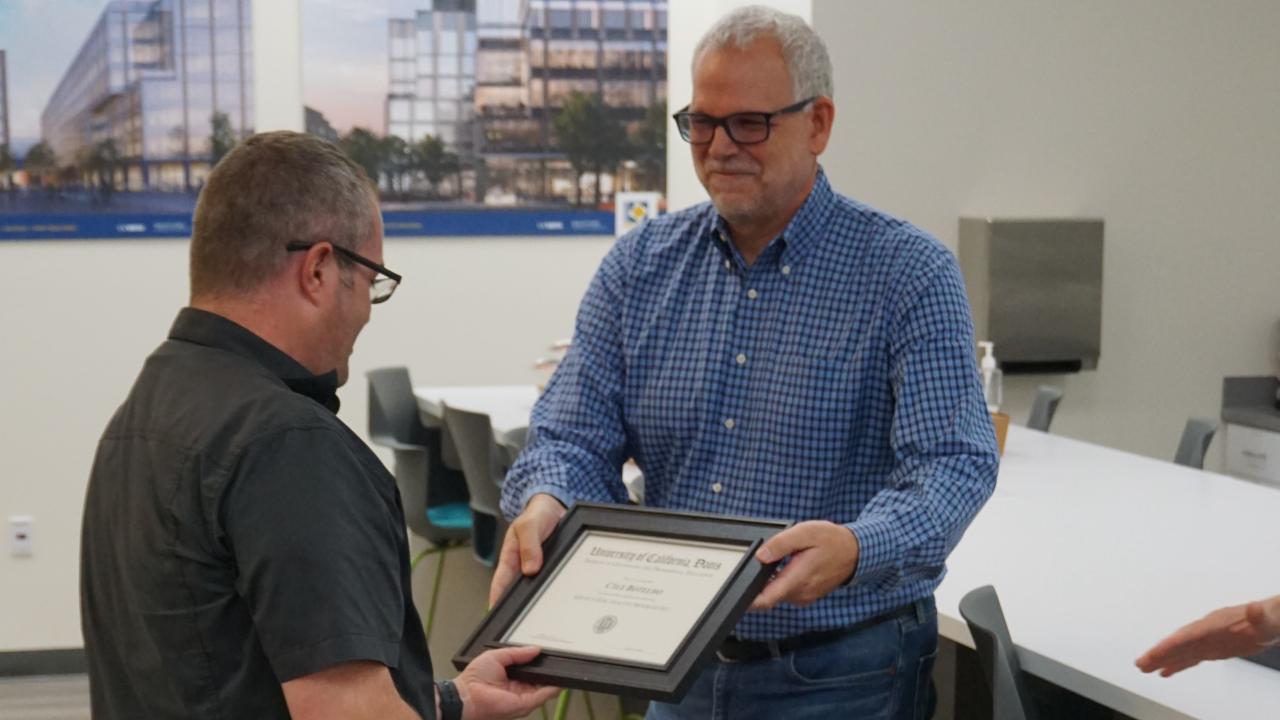 A UC Davis Tech Pathways participant receives a certificate