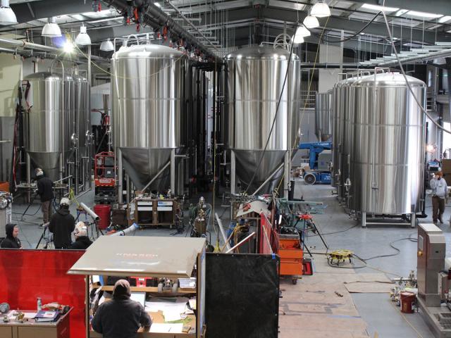 brew tanks and equipment arranged in an orderly manner during the installation phase at Seismic Brewing