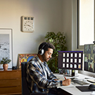 man working at desk during online meeting